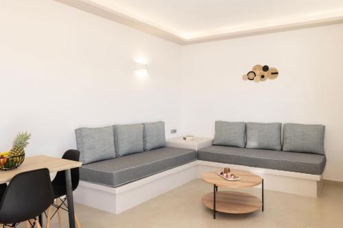 a living room with a couch and a table at Windmillside Luxury Villas in Emporio Santorini