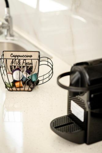 a coffee cup in a wire basket on a counter at Windmillside Luxury Villas in Emporio Santorini