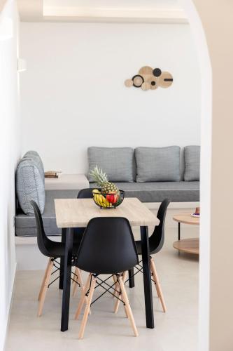 a table and chairs in a living room with a couch at Windmillside Luxury Villas in Emporio Santorini