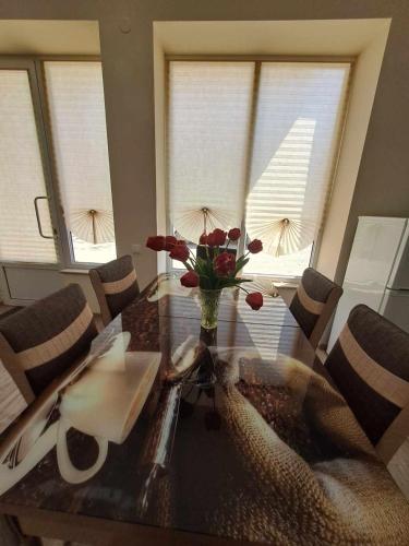 a dining room table with a vase of flowers on it at Hasmik house in Areni
