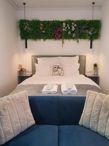 a bedroom with a bed with two towels on it at Premium Hils Brauner Studio in Bucharest