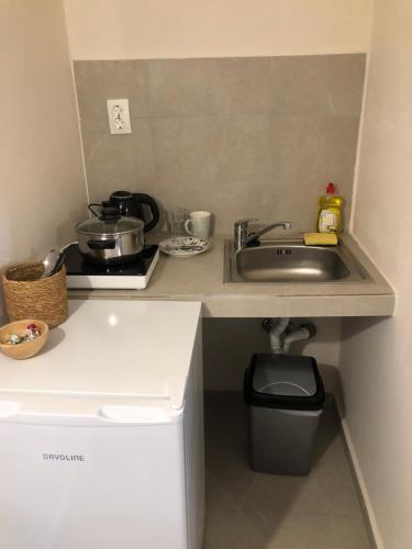 a small kitchen with a sink and a stove at Solo traveler in Ermoupoli