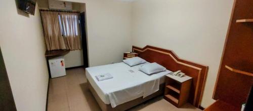 a small room with a bed in a room at Aero Plaza Hotel in Sao Paulo