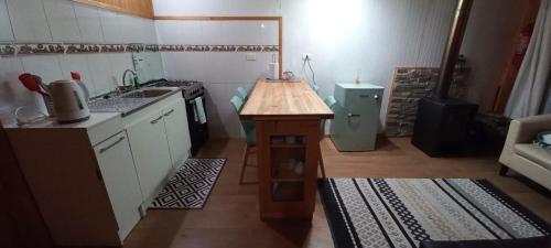 a small kitchen with a counter and a sink at Cabañas MAWEN in Chaitén