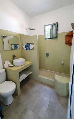 a bathroom with a toilet and a sink and a shower at Pefkos Eye in Pefki Rhodes