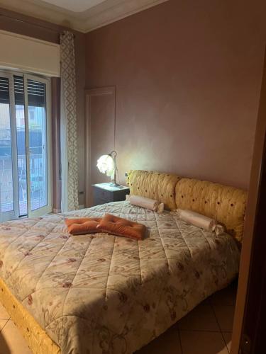 a large bed in a bedroom with a large window at Specter Guesthouse in Nettuno
