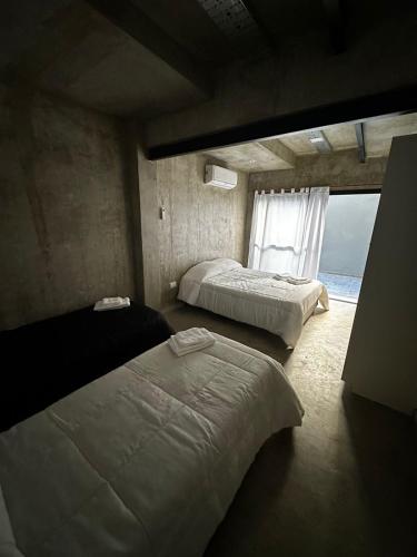 a bedroom with two beds and a window at DOCTA RESIDENCIA in Cordoba