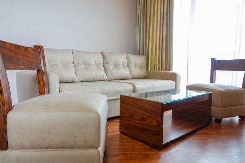 a living room with a couch and a coffee table at Luxury Dreamland Oasis Apartments in Chakvi