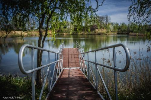 a bridge over a body of water at Forteca, pokoje gościnne nad stawem in Dzierżoniów