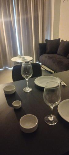 una mesa con platos y copas de vino. en Alojamiento de lujo! G&A Rent! (101) en Ezeiza