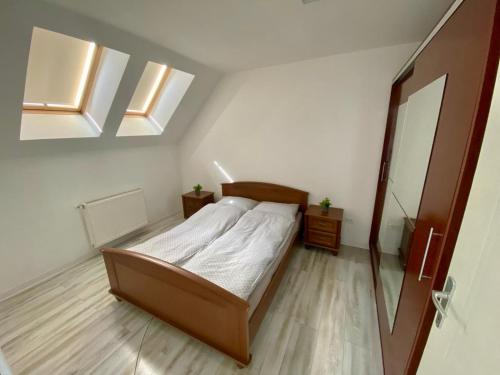 a bedroom with a bed and a mirror and skylights at Like Home in Arad