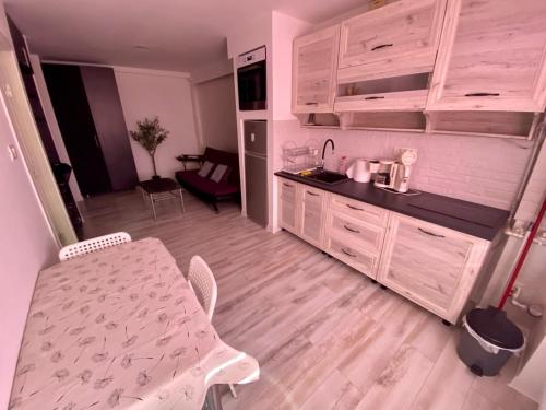 a kitchen with a table and a small kitchen with a table and chairs at Like Home in Arad