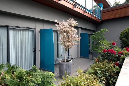 a tree in a pot next to a building at Qualicum Beach Inn in Qualicum Beach