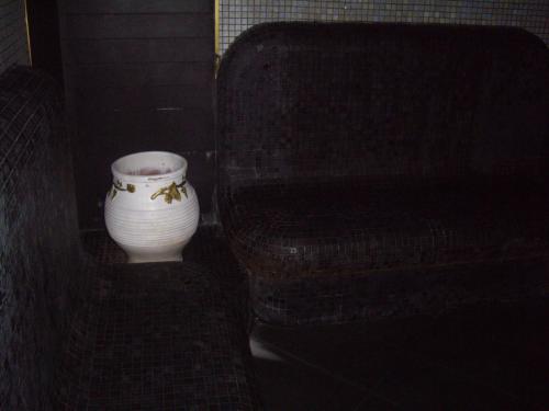 a white vase sitting next to a chair at STUDIO DELUXE IN MARINA CAPE 4 stars complex 33 7 in Aheloy
