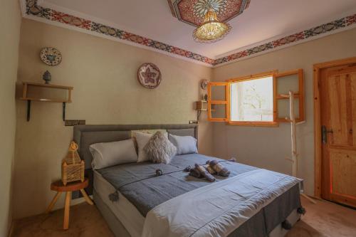 a bedroom with a bed with shoes on it at Atlas Haven in Imlil
