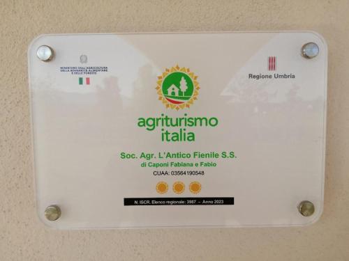 a sign on a wall that says autoimmune itlia at L'Antico Fienile in Montefalco