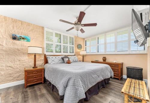 a bedroom with a bed and a ceiling fan at Kanai A nalu in Wailuku