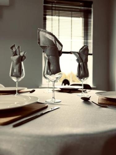 a table with two wine glasses on top of it at Lakeland Living - Devenish Manor in Enniskillen