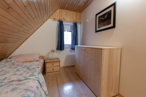a bedroom with a bed and a wooden ceiling at Metoja in Soča