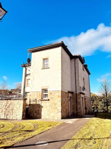 a large brick building on the side of a road at Lakeland Living - Devenish Manor in Enniskillen