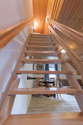 a staircase in a house with wooden ceilings at Metoja in Soča