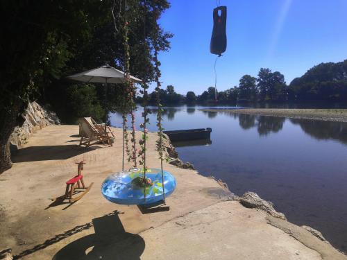 a swing on the side of a body of water at Drinski kej in Zvornik