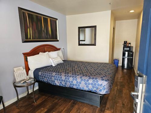 a small room with a bed and a table at California Suites Motel in Calexico