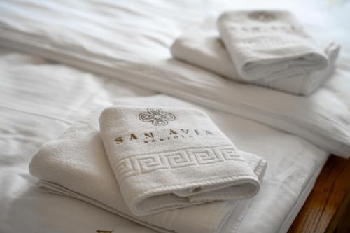 three white towels sitting on top of white beds at Luxury Apartments Villa San Avia in Banjole