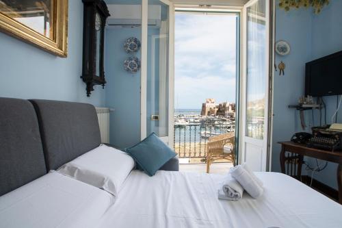 a bedroom with a bed with a view of the ocean at Liberty house in Castellammare del Golfo