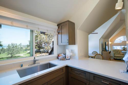 a kitchen with a sink and a window at Wave Crest Resort in San Diego