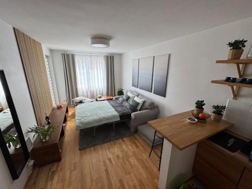 a small living room with a bed and a table at Marina Primore Apt nad morzem in Gdańsk