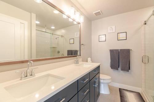 a bathroom with a sink and a toilet and a mirror at Park City Modern New Park City Townhome in Park City