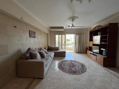 a large living room with a couch and a rug at 2 Bedroom Chalet, Private Garden Ain El Sokhna in Ain Sokhna