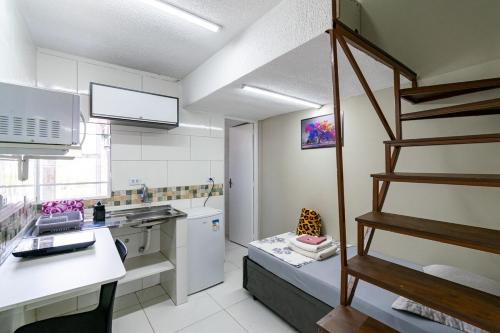 a kitchen with a spiral staircase in a room at 57 LOFT QUADRUPLO · LOFT completo perto da São Paulo EXPO in São Paulo