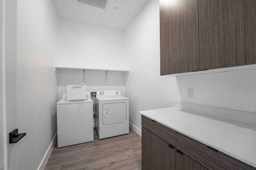 a small kitchen with a stove and a refrigerator at Modern Townhome in Arcadia ~ Pool & Private Yard in Phoenix