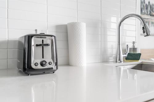 a toaster sitting on a kitchen counter next to a sink at Jarvis Apartment in Toronto