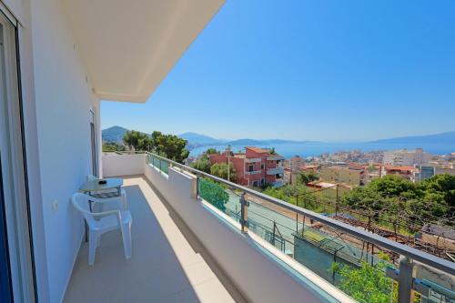 a balcony with a table and a view of a city at Villa e Olsi Kacupaj in Sarandë