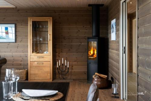 a stove in a room with a table with a fireplace at Nesfjellet in Nes i Ådal