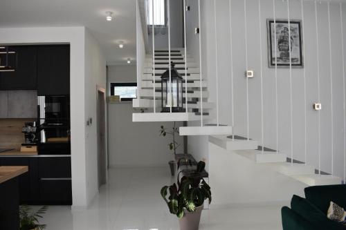 a living room with a staircase in a house at Villa Lauvi, Free Fiat 500 Cabriolet, Scooters , PS5 in Kaštela