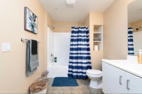 a bathroom with a blue and white shower curtain at spacious two bedroom 2 bath close to Disney Adventure Park in Anaheim