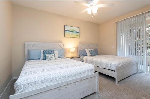 a bedroom with two beds and a window at spacious two bedroom 2 bath close to Disney Adventure Park in Anaheim