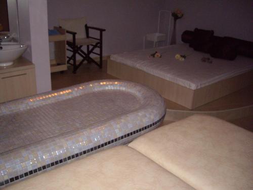 a living room with two beds and a bath tub at STUDIO DELUXE IN MARINA CAPE 4 stars complex 33 7 in Aheloy