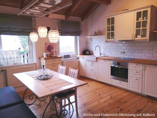 a kitchen with a table and a table and chairs at Ferienwohnungen zentral Altötting in Altötting