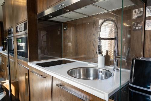 a kitchen with a sink and a stove at Luxury Studio Flat Victoria SW1 in London