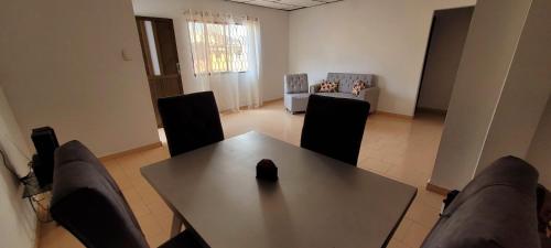 a dining room with a table and chairs and a couch at APARTAHOTEL HEFZIBA in Barranquilla
