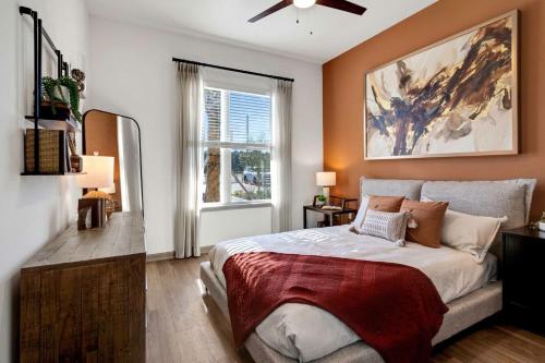 a bedroom with a large bed and a window at RISE Bartram Park Condos by Barsala in Jacksonville