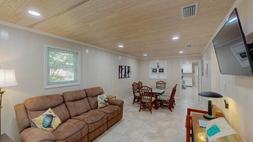 a living room with a couch and a dining room at BEACHY SISTERS B Duplex in Jekyll Island