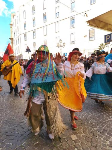 a group of people in costumes walking down a street at KALGHEROS Luxury Rooms in Agrigento