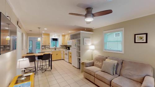 a living room with a couch and a kitchen at BEACHY SISTERS A Duplex in Jekyll Island