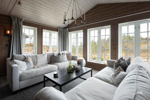 a living room with a couch and a table at Nesfjellet in Nes i Ådal